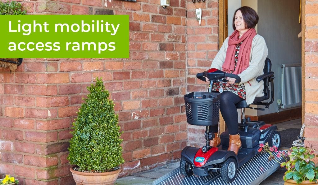woman driving mobility scooter down an aerofold ramp
