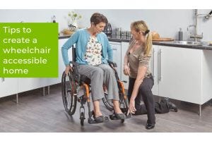Woman in a wheelchair in her kitchen with an OT