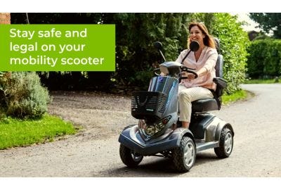 woman riding a mobility scooter along a road