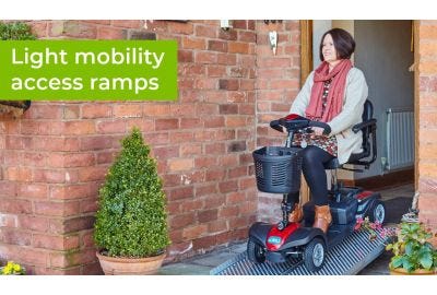 woman driving mobility scooter down an aerofold ramp