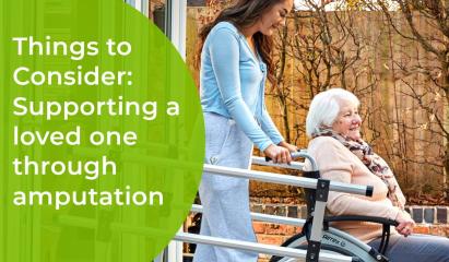 elderly amputee in wheelchair being pushed by caring relative