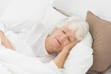 elderly woman sleeping in bed