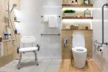 accessible bathroom with grab rails, shower chair