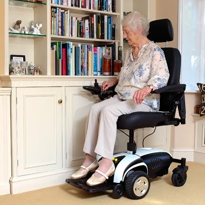 Lady using an Electric Wheelchair in her home