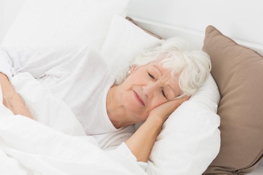 elderly woman sleeping in bed