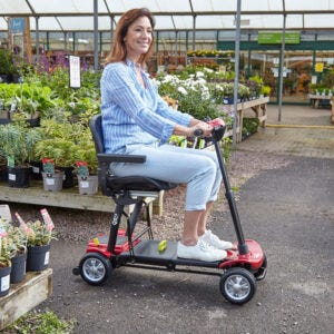 Woman riding the mobility scooter in a garden centre