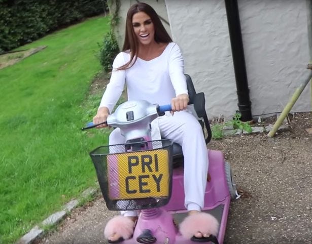 Katie Price sitting on her pink mobility scooter