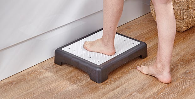 woman stepping onto a bath step