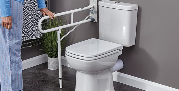 folding hand rail next to a toilet