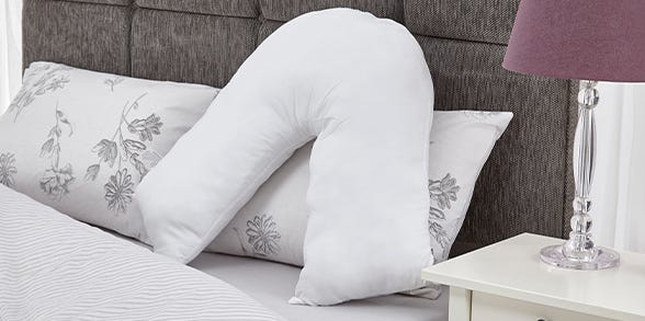 V-Shaped Pillow on bed