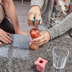 Somebody using a bottle cap opener 