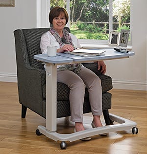 woman sat on armchair with an adjustable table