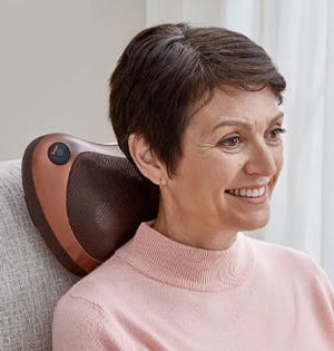 Woman sitting in chair using Lumbar Massager Cushion