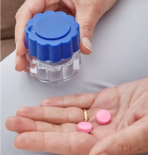 woman holding medication and a pill crusher