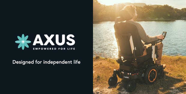 man on an outdoor powerchair looking over a lake