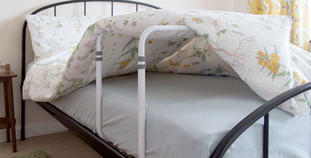 bed cradle with a mattress over it