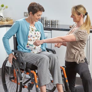 OT helping size a wheelchair