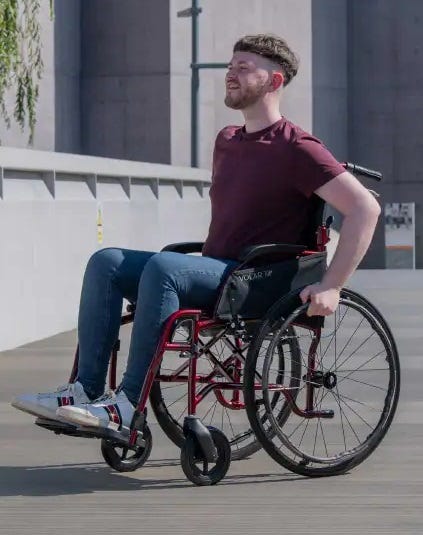 man using a self-propelled wheelchair