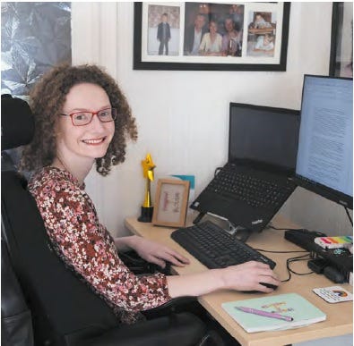 Hannah sitting at her desk