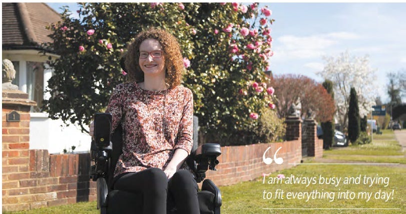 Hannah outside her house on her powerchair