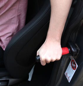 person holding a Car Handle for support