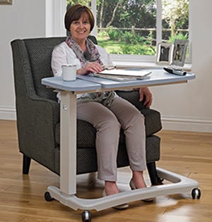 woman sat on a chair using an adjustable table