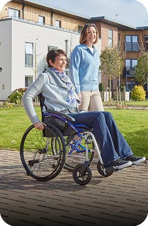 woman riding a blue mobility scooter by a shop