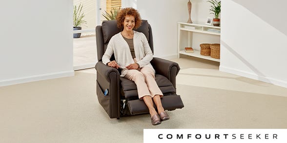Woman reading in a small grey riser recliner