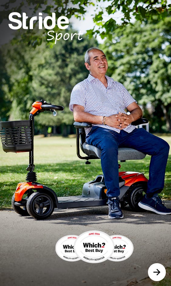 Woman pushing an elderly man in a wheelchair outside on a sunny day