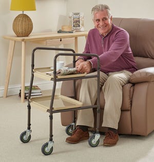 man using the homehelp trolley from his armchair