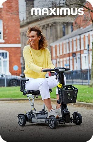 woman riding a purple mobility scooter by a green