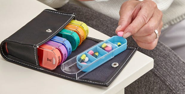 woman organising pills in a pill pouch
