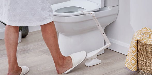 person using a foot controlled toilet seat lifter