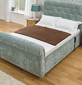 brown Waterproof Bed Protector on a double bed