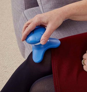 woman massaging her leg with a Waterproof Massager