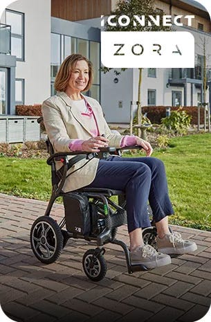 Woman riding a small mobility scooter in a garden centre